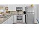 Well-equipped kitchen features granite countertops, stainless steel appliances, and modern cabinetry at 5400 Kings Camp Cabin 16 Se Rd, Acworth, GA 30102