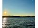A view of the lake at sunset showing the water and horizon and mountains in the distance at 5400 Kings Camp Cabin 16 Se Rd, Acworth, GA 30102