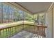 Side view of a wooden porch overlooking the large yard and green foliage at 5400 Kings Camp Cabin 16 Se Rd, Acworth, GA 30102