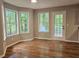Bright dining area featuring hardwood floors, large windows, and a glass door leading to the outside at 14 Highland Dr, Carrollton, GA 30116