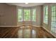 Bright dining area featuring hardwood floors, large windows, and a glass door leading to the outside at 14 Highland Dr, Carrollton, GA 30116