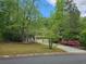 Charming home featuring a front porch, two-car garage, and a well-maintained front yard surrounded by mature trees at 14 Highland Dr, Carrollton, GA 30116
