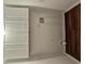 Well-lit laundry room with laminate flooring, white cabinets, and washer/dryer hookups at 14 Highland Dr, Carrollton, GA 30116
