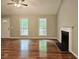 Spacious living room with hardwood floors, fireplace, and large windows bringing in natural light at 14 Highland Dr, Carrollton, GA 30116