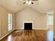Bright living room featuring a fireplace, wood floors, and large windows offering scenic views at 14 Highland Dr, Carrollton, GA 30116