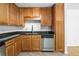 Kitchen showcasing wood cabinets, granite counters, stainless dishwasher, and wine glass rack at 1468 Briarwood Ne Rd # 602, Atlanta, GA 30319