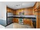 Modern kitchen featuring stainless steel appliances, wood cabinets, and granite countertops at 1468 Briarwood Ne Rd # 602, Atlanta, GA 30319