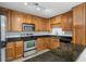 Updated kitchen features stainless appliances, granite counters, track lighting, and wood cabinets at 1468 Briarwood Ne Rd # 602, Atlanta, GA 30319