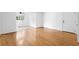 Bright living room featuring gleaming hardwood floors and a white front door at 1468 Briarwood Ne Rd # 602, Atlanta, GA 30319