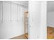 Walk-in closet space with wooden shelves and access to additional storage at 1468 Briarwood Ne Rd # 602, Atlanta, GA 30319