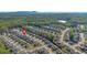 Aerial view of the neighborhood surrounded by trees and hills at 4655 Bluffton Ct, Cumming, GA 30028