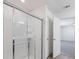 Modern bathroom featuring sliding glass shower doors and a view into the bedroom at 4655 Bluffton Ct, Cumming, GA 30028
