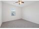 Bright bedroom with neutral carpet, ceiling fan, and large window bringing in lots of natural light at 4655 Bluffton Ct, Cumming, GA 30028