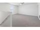 Large carpeted bedroom with a ceiling fan and windows, next to the stairwell at 4655 Bluffton Ct, Cumming, GA 30028