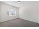 Well-lit bedroom features neutral paint and carpet along with a window at 4655 Bluffton Ct, Cumming, GA 30028