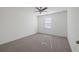 This bedroom boasts neutral carpeting, a ceiling fan, and ample natural light from the window at 4655 Bluffton Ct, Cumming, GA 30028
