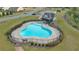 Aerial view of the community pool, featuring a fenced area and a nearby shaded pavilion at 4655 Bluffton Ct, Cumming, GA 30028