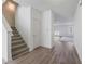Inviting entryway with carpeted stairs, a coat closet, and views of the living room with wood-look flooring at 4655 Bluffton Ct, Cumming, GA 30028