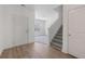 Fresh entryway with gray carpet on the stairs, wood-look flooring, and a door to the garage at 4655 Bluffton Ct, Cumming, GA 30028