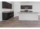 Stylish kitchen featuring dark wood cabinets, granite countertops, and a large island with bar seating at 4655 Bluffton Ct, Cumming, GA 30028