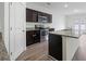 Well-lit kitchen with stainless steel appliances, granite counters, a large island, and dark wood cabinets at 4655 Bluffton Ct, Cumming, GA 30028