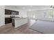 Bright, airy living room flows into a kitchen with granite countertops, and sliding glass doors to the outdoors at 4655 Bluffton Ct, Cumming, GA 30028