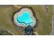 Aerial view of a modern community pool surrounded by well-maintained landscaping and a fence at 4655 Bluffton Ct, Cumming, GA 30028