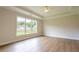 Spacious bedroom with hardwood floors, ceiling fan, and large windows providing natural light at 5325 Keepsake Court, Cumming, GA 30040