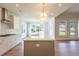 Modern kitchen featuring an island, stainless steel appliances, and natural light at 5325 Keepsake Court, Cumming, GA 30040