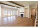 Spacious living area with a fireplace, wood floors, and natural light at 5325 Keepsake Court, Cumming, GA 30040