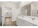 Bathroom vanity with double sinks, large mirror, and a view into an adjoining room at 600 Silver Moon Dr, Loganville, GA 30052