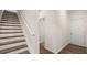 Hallway featuring stairs with wood treads, white risers, and wood-look floors at 600 Silver Moon Dr, Loganville, GA 30052
