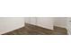 Hallway with wood look floors, white baseboards and trim, and several doorways at 600 Silver Moon Dr, Loganville, GA 30052