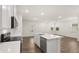 Spacious living area with hardwood floors, island and natural light, creating a welcoming and airy space at 600 Silver Moon Dr, Loganville, GA 30052