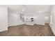 Open concept living space with hardwood floors and a kitchen in the background at 600 Silver Moon Dr, Loganville, GA 30052