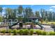 Community playground with slides and climbing structures with mature trees in the background at 600 Silver Moon Dr, Loganville, GA 30052