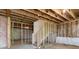 Partially framed basement featuring a staircase, offering customization options at 7515 Woolf Way, Cumming, GA 30028