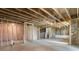 Unfinished basement with exposed framing and insulated walls offers customization at 7515 Woolf Way, Cumming, GA 30028