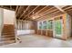 Unfinished basement provides natural light with exterior access, and staircase at 7515 Woolf Way, Cumming, GA 30028