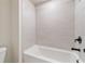 Modern bathroom featuring a tiled shower and sleek fixtures at 7515 Woolf Way, Cumming, GA 30028