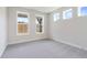 Bright, airy bedroom with three large windows, neutral carpet, and freshly painted walls at 7515 Woolf Way, Cumming, GA 30028