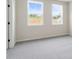 Bright, carpeted bedroom with two windows providing lots of natural light at 7515 Woolf Way, Cumming, GA 30028