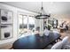 Bright dining room with modern lighting, stylish decor, and sliding glass doors to the outdoor patio at 7515 Woolf Way, Cumming, GA 30028