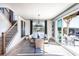 Bright dining area with backyard access, modern light fixture, and home stairwell at 7515 Woolf Way, Cumming, GA 30028
