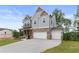 Lovely two-story home with a brick and gray exterior, covered porch, and a three-car garage at 7515 Woolf Way, Cumming, GA 30028