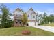 Attractive two-story home with a manicured lawn, covered porch, and a three-car garage at 7515 Woolf Way, Cumming, GA 30028