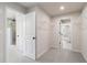 Neutral-toned hallway provides seamless transition with an ensuite and additional rooms at 7515 Woolf Way, Cumming, GA 30028