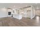 A modern kitchen features stainless steel appliances, white cabinetry and an island with a white countertop at 7515 Woolf Way, Cumming, GA 30028