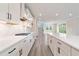 A modern kitchen features white countertops, shaker cabinets, and stainless steel appliances at 7515 Woolf Way, Cumming, GA 30028