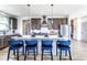 Modern kitchen with stainless steel appliances, sleek countertops, and stylish blue bar stools at 7515 Woolf Way, Cumming, GA 30028